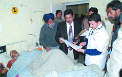 The Director, Health Services, Punjab, Dr Ashok Nayyar, checks a patients file during his surprise visit to the Civil Hospital in Bathinda on Monday. Tribune photo: Pawan Sharma