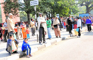 Commuters wait for buses outside the PGI in Chandigarh on Monday. 