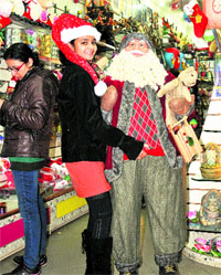 A girl with a ~18,000 Santa Claus on the eve of Christmas at a shop in Sector 11, Chandigarh . 