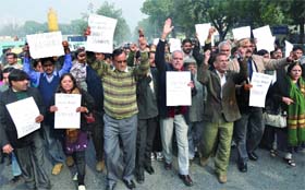 Journalists shout slogans during a protest against the Delhi police in New Delhi on Monday