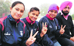 (From left) Gagandeep Kaur, Kiran an Pooja with coach Iqbal Sing at the hadball court in Sector 42, Chandigarh on Tuesday. 