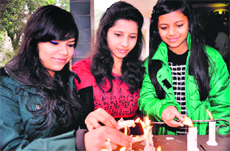 Girls light candles as part of Christmas prayers in Haridwar on Tuesday.