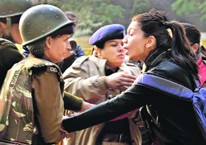 Policemwomen detain a protester at Jantar Mantaron Tuesday.