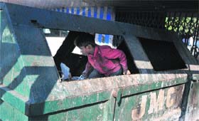 ALL WORK, NO PLAY: A child collects garbage from a bin in Jammu