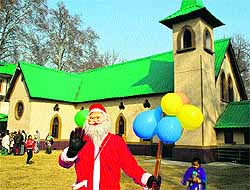 A local dressed as Santa Claus at the Holy Family Catholic Church in Srinagar on Tuesday