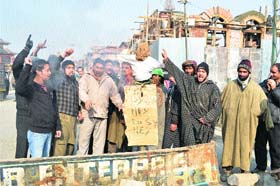 Protesters burn an effigy of the state government in support of their demands in Srinagar on Tuesday