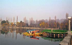 A view of the Dal Lake with shikaras moored at a jetty on Tuesday