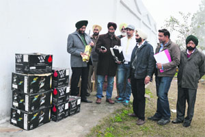 The raiding team of the Excise and Taxation Department with the seized liquor boxes at Hardy's World 