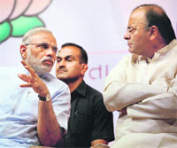 Gujarat Chief Minister Narendra Modi with senior BJP leader Arun Jaitley during a meeting with newly elected MLAs in Gandhinagar on Tuesday.