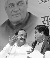 BJP president Nitin Gadkari (R) with M Venkaiah Naidu at the Vishal Jan Sabha organised to celebrate party veteran Atal Bihari Vajpayee's birthday as Sushasan Diwas in New Delhi on Tuesday. 