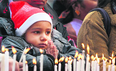 A child prays at New Delhi's Sacred Heart Cathedral on Tuesday. 
