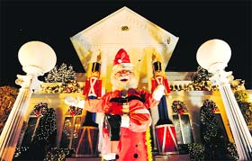 A giant Santa Claus in front of a decorated house on Christmas in the Dyker Heights neighbourhood of the Brooklyn borough of New York City