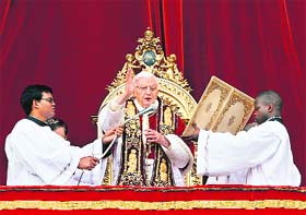Pope Benedict XVI blesses the crowd as he makes his To the city and the world address from a balcony in St Peter's Square in Vatican on Tuesday