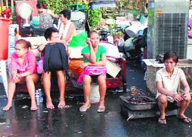 Residents hold on to their belongings along a road after fire razed over 500 houses in a residential area of San Juan City, Metro Manila, on Tuesday
