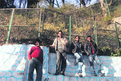 Tourists bask in the sun at a vantage point in Mussoorie on Wednesday.