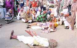 Senior citizens block traffic to protest the deletion of their names from the list of beneficiaries for old-age pension in Sirsa on Wednesday. A Tribune photograph