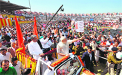 Gujarat Chief Minister Narendra Modi waves to supporters after his swearing-in at the Sardar Patel Navrangpura Stadium in Ahmedabad on Wednesday.  AFP