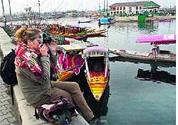 A tourist clicks photographs of the Dal Lake in Srinagar on Wednesday