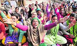 Members of J&K Anganwari Workers and Helpers Union stage a protest in Jammu on Wednesday