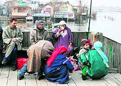 People enjoy tea on the banks of the Dal Lake in Srinagar on Wednesday