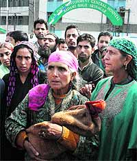 A woman carries the body of an infant who died at the GB Pant Hospital, Srinagar, triggering protests by attendants on May 19 this year