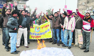 Government teachers working on contractual basis stage a protest at Bharat Nagar Chowk in Ludhiana on Wednesday. 