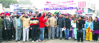Residents raise slogans during a solidarity march in Samrala on Wednesday. 