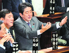 Shinzo Abe (R) with leaders in the lower house of Parliament in Tokyo on Wednesday. 