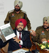 IG, Bathinda zone, Nirmal Singh Dhillon, shows the complaint box to be installed in schools and colleges. SSP Ravcharan Singh Brar is seated next to him. 