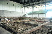 Work on an indoor basketball stadium goes at a snails pace.