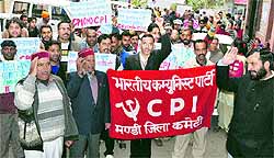 CPI and CPM activists hold a protest in front of Zonal Hospital, Mandi, on Thursday