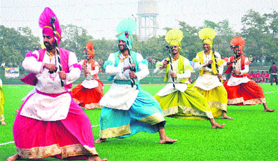 Artistes perform bhangra at the opening of the 15th Annual Steel Olympian Mohinder Munshi Hockey Tournament at PAP, Jalandhar, on Thursday.