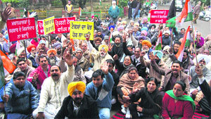 Congress workers stage a dharna outside the Municipal Council office in Kapurthala on Thursday