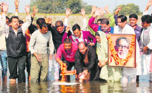 Members of the local unit of the Shiv Sena immersed ashes of Bal Thackeray in the Tawi river in Jammu on Thursday. 