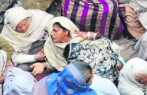 Relatives mourn the death of Manjit Kaur and her four children in Thothian village near Amritsar on Thursday.