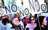 Demonstrators take part in a rally against the local government's plans to cut spending on public healthcare outside Madrid's health regional office in Spain on Thursday