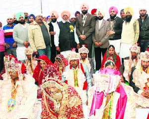 Revenue Minister Bikram Singh Majithia blesses newlywed couples at a mass marriage ceremony at Majitha on Friday.