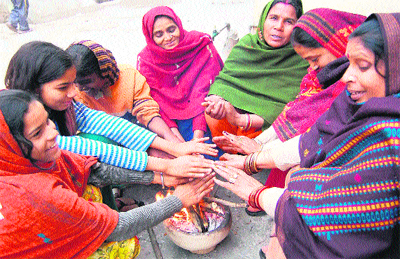 With the minimum temperature touching 3 Celsius in Haridwar on Friday, women sit around a bonfire to beat the heat. 
