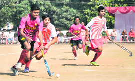 Players of PNB Delhi and BSES Delhi vie for the possession of the ball during the first semifinal match at Gurukul Kangri University in Haridwar on Friday. The BSES team won the match 1-0. 
