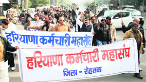Members of Haryana Karamchari Mahasangh hold a protest in Rohtak on Friday. 