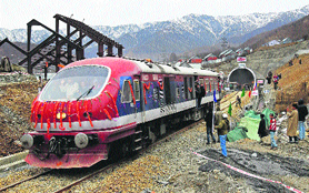People welcoming the train as it emerges from the Pir Panjal tunnel during a trial run in Banihal on Friday. 