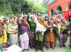 Women shout slogans in Gurdaspur on Friday. A Tribune photo