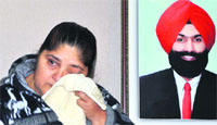 Manjeet Kaur, widow of ETO Ranjit Singh, wipes her tears at a press conference in Mohali on Friday. A Tribune photograph