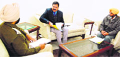 Rajkumar Verka, vice-chairman, National Commission for SCs/STs, listens to the Batala DSP Kirpal Singh. Tribune photo