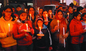 Social activists and students of schools and colleges came together on Saturday evening at Fire Brigade Chowk to light candles and pray for the bereaved family of the girl who died after being gang raped in a moving bus in Delhi.