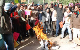 Members of the Sarva Shiksha Abhiyaan (SSA) and Rashtriya Madhyamik Shiksha Abhiyaan (RMSA) Non-teaching Employees Union, Punjab, burn an effigy of the state government outside the District Administrative Complex in Bathinda on Saturday. The union was agitating against the government for the non-fulfillment of its long-pending demands.