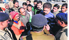 Traders and local people hold a protest in Haridwar on Saturday against the thrashing of two employees of a sweets shop by a policeman.