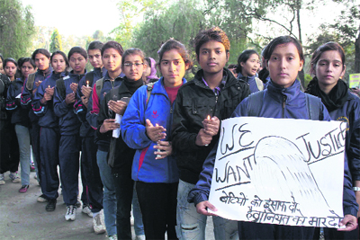 Girls hold a candle vigil at Gandhi Park in Dehradun on Saturday following the death of the Delhi rape victim.