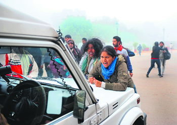 Girls vent their anger at cops in a police jeep during the agitation against the gang rape of the 23-year-old in New Delhi.