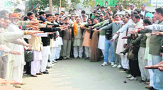 Activists of the BJP and HJC take a pledge to work for the safety and security of women during a protest at Shubhash Chowk in Sonepat on Saturday.